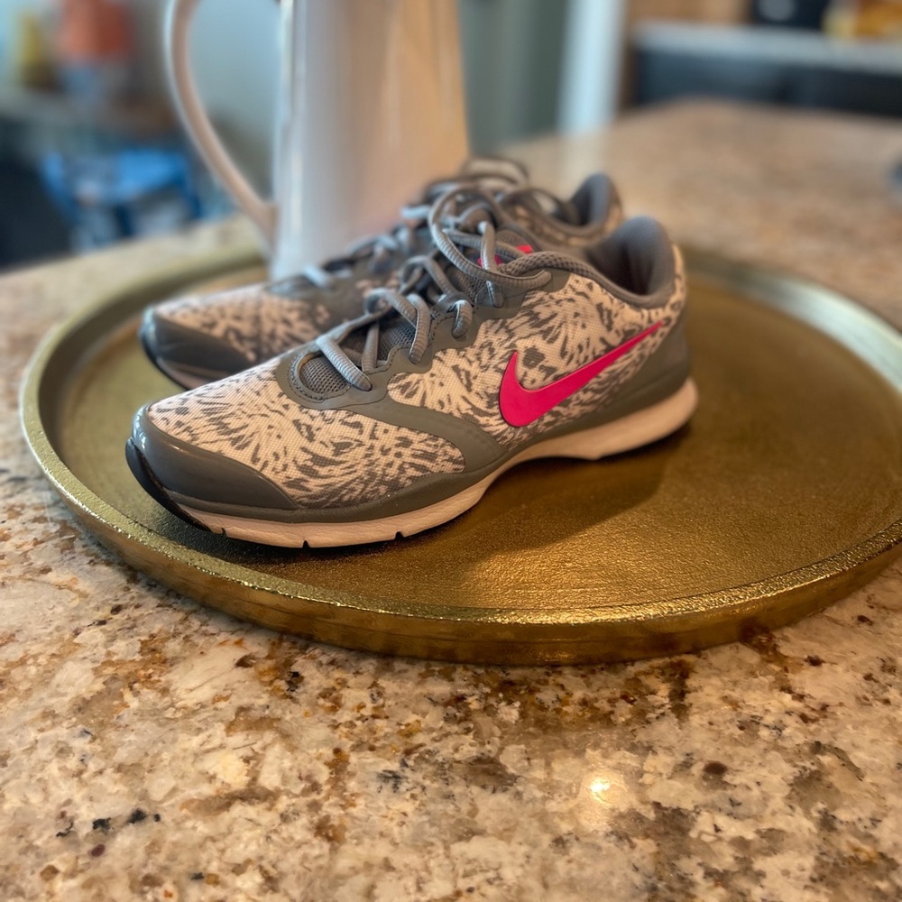 Super cute gray and white Nikes with a pink swoosh
